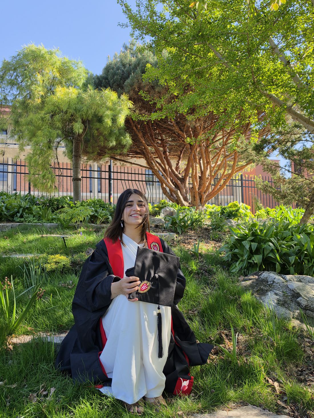Irhah Arshad Siddiqui at her graduation, holding her cap, on the UW&ndash;Madison campus