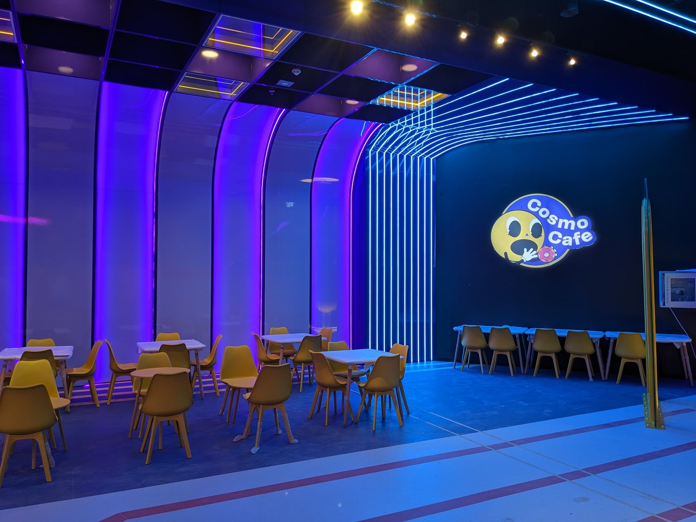 The Flipped cafe seating area with yellow and green chairs