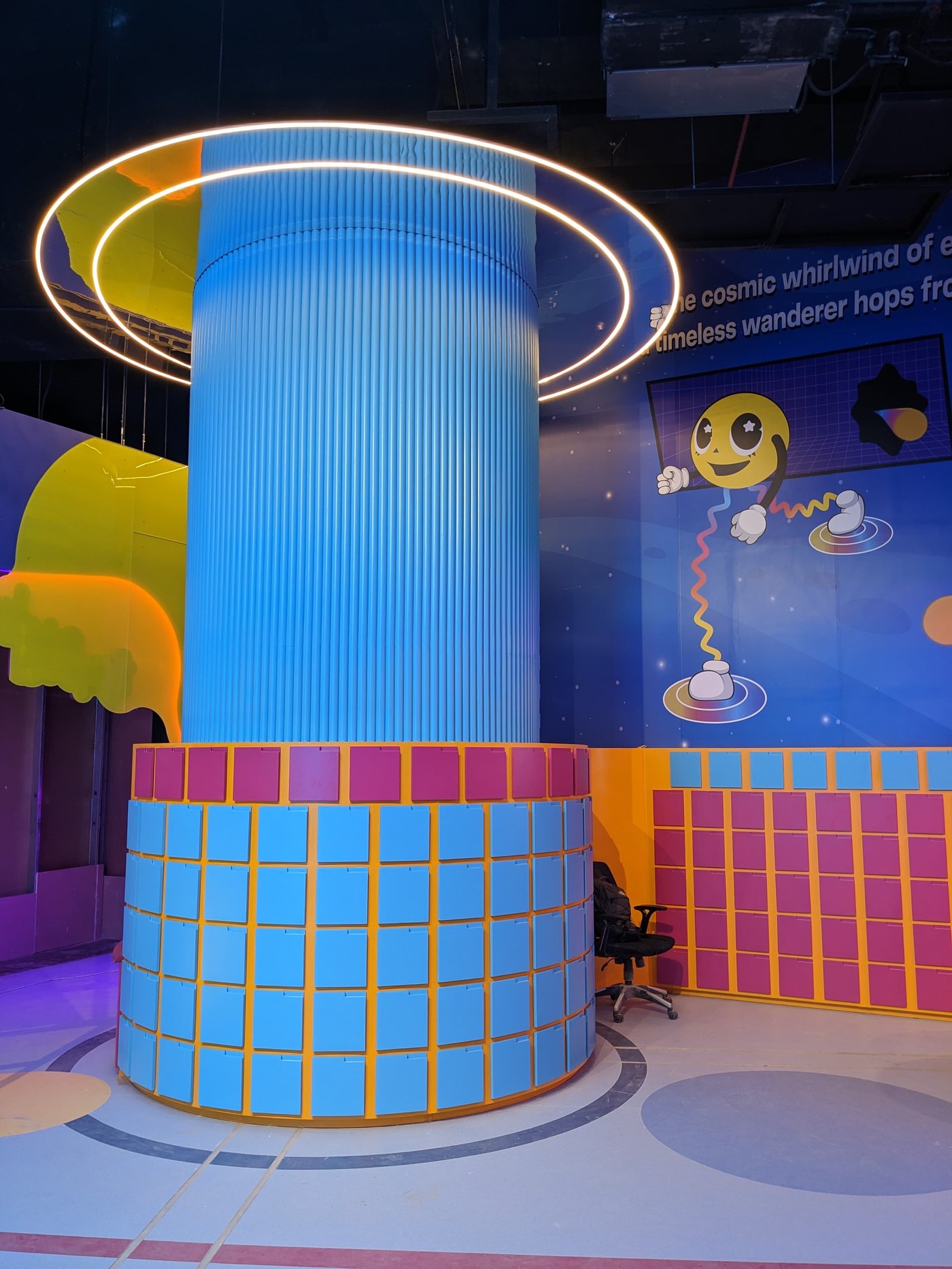 A glowing blue ring light tower feature in the play area
