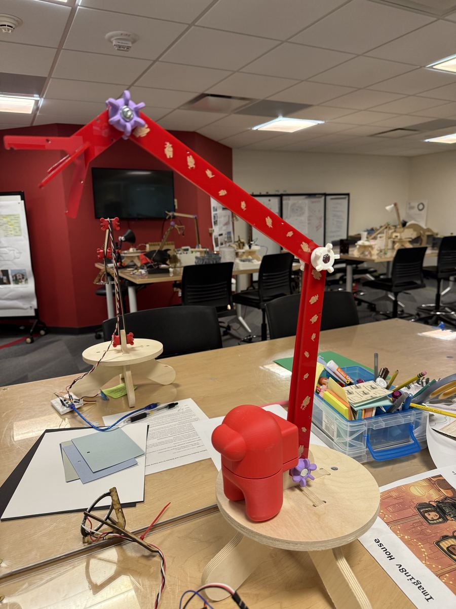 The arm prototype with a red crewmate figure beside the stool